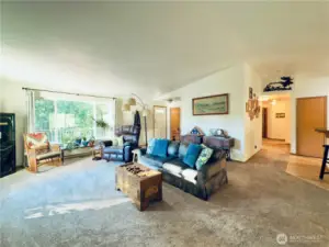 Living room with views to entryway and hallway to bedrooms