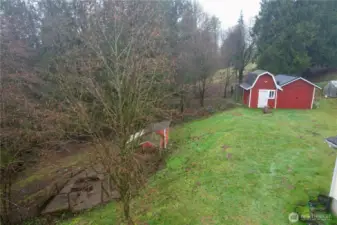 Outbuildings on acreage, fenced for chickens and other small farm animals, fruit trees, garden areas, creek access