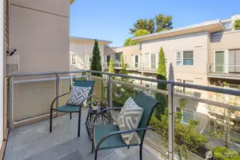 Balcony overlooks the manicured courtyard below.