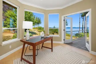 The office is to the left of the front door and has access to the wrap-around deck