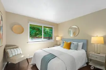 The third bedroom, with dark wood floors and a pleasant outlook.