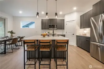 Modern Kitchen with upgraded appliances, backsplash, and walk in pantry.
