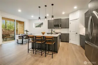 Modern Kitchen with upgraded appliances, backsplash, and walk in pantry.