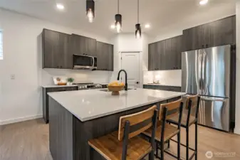 Modern Kitchen with upgraded appliances, backsplash, and walk in pantry.