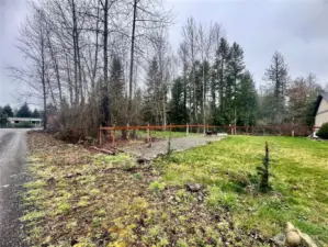 The property to the side of the home, from the street.