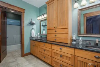 Bathroom with custom granite counters, dual sinks, and a radiant heated floor