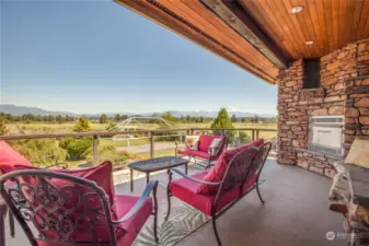 The upstairs balcony features mountain views, wood soffit ceilings, and a gas fireplace