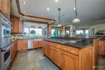 The professionally equipped, but exceptionally user friendly kitchen features a 6 burner Dacor gas cooktop, dual Viking refrigerators, Viking ovens, an eating bar, slate tile flooring with radiant heat, Sonos In Room Audio  and granite counters.  There is extensive cabinet storage.