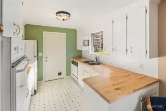 Light, bright kitchen with restored original cabinets & new butcher block countertops