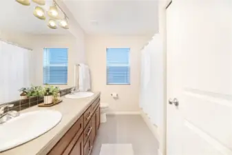 Guest bathroom with deep bathtub and dual sinks