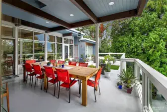 The Covered Deck off the main level extends the home’s social heart outdoors—an all-season gathering space suspended in treetops. With overhead beams, integrated lighting, and seamless flow from the dining and kitchen areas, it’s ideal for everything from sunrise coffee to sunset dinners under a canopy of Northwest sky.