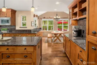 Coffee Bar with sink, beverage fridge (disguised with cabinet front!), open cabinet storage and glass front shelves. Pull out the shelves on the far right for a suprisingly large pull-out pantry! So well designed!