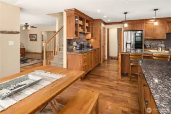 Fron Breakfast Nook towards kitchen, living room and stairway to upper level.