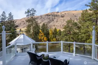 Deck View: The riverside deck and gazebo overlook a scenic river valley, offering an idyllic setting for outdoor living and gracious entertaining.