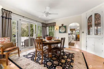 Charming dining room with built-in corner hutch and French doors that open directly to the view deck—seamlessly blending indoor comfort with outdoor entertaining.