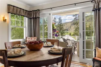 Enjoy every season from this cozy dining space—whether it's colorful summer blooms just outside the door or a winter wonderland straight from a Hallmark movie.