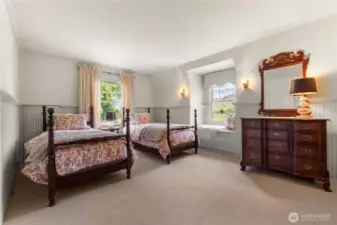 Light-filled upstairs bedroom with dormer window seat and serene views of pasture and surrounding hills.
