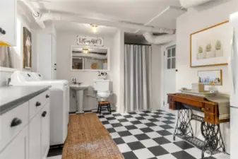 Bright and spacious lower-level laundry with generous storage, ¾ bath, and access to the outdoor cellar   door—classic charm meets practical convenience, plus a convenient wine cellar or cold storage pantry.