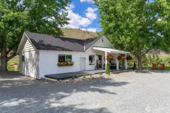 Charming 2-bedroom guest house with covered porch, flowering window boxes, and private deck—ideal for hosting friends, extended stays, or enjoying your own tranquil retreat.