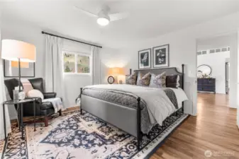 Light-filled and peaceful, the guest house primary room offers a cozy retreat with scenic views.