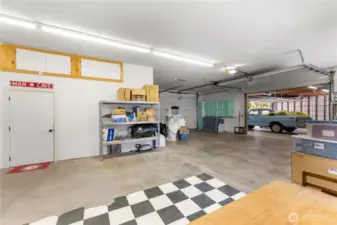 Insulated workshop with workbenches, bathroom, air compressor system, and plenty of space for projects or business use.  Plus, spacious 3-bay equipment garage with built-in shelving, storage, and attached office—ideal for tools, trucks, and weekend projects.