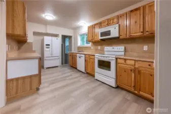 The kitchen is delightful to cook in, even with multiple chefs.  Through the door by the fridge is the large mudroom/laundry room, and stairs to the lower level.  Let's head down.