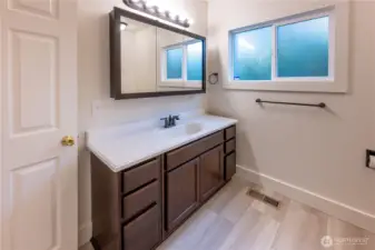 The bathroom on the main floor has nice flooring, and, just like everything in this home, is big.