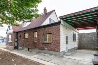 Side view of home and covered patio.  The flat roof portion of the home is one year old.