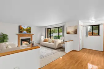 Large front room (virtually staged) with new carpet and gas fireplace