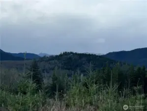 SW facing view. Snow capped mountain peaks, peeking at you from afar.