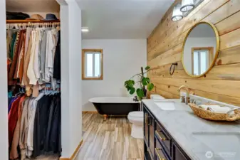 Primary bathroom with claw foot tub and custom shower