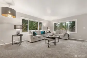 There's so much room in this formal living room! And look at those gorgeous, large vinyl windows carrying the outdoors, inside!