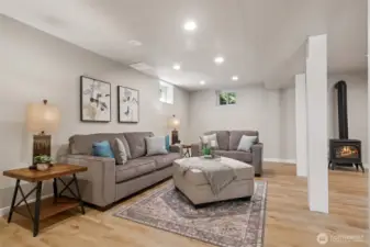 One half of the lower level rec room/bonus room/family room, living quarters. (We love the gas stove! -- So cozy in the winter months!)