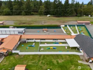 Outdoor dog play yards with k9 grass Astroturf, as well as sand play yards.