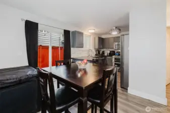 Dining room and eat-in kitchen with sliding glass door leading to the back patio.