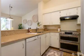 The kitchen is spacious and offers loads of cabinet space. The open Floor plan ensures you can be in the kitchen and still enjoy those gorgeous PNW mountain views. Newer double oven. Quartz counters and ceramic tile floors.and still enjoy interactions throughout the main living area.