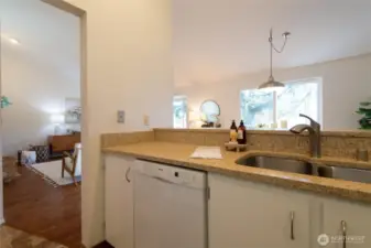 The warm tones of the quartz countertops in this home’s main living area complement the soft, neutral color palette nicely.