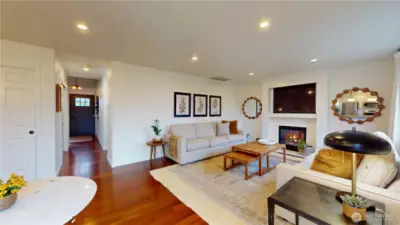 Family room with cozy gas fireplace.  You can also see down hall to front door