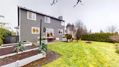 Fenced backyard with garden area.  Fun patios.  Upper shown with table and lower patio has space for seating