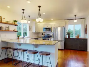 Pictures do not do this kitchen justice. Open and Inviting! Room for multiple cooks. Curved granite counter seats five!