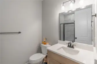 Main level bath off of entry and den