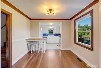Next is the dinig area with a breakfast bar and stools that convey.