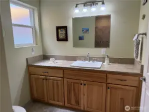 Beautiful cabinets continue into the large bathroom.