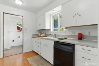 Kitchen leads to laundry room, half bath and back door.