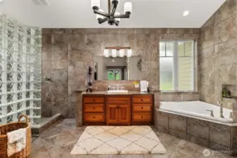 Primary Bathroom with walk in shower, soaking tub and walk in closet