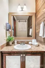 Shiplap wall creates a beautiful first floor guest bath.