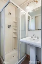 Another view of the bathroom sink and shower.