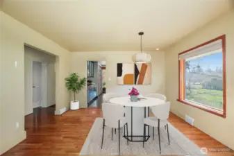 Dining Room  Beautiful hardwood floors with 5-1/2” painted baseboard trim. Virtually Staged