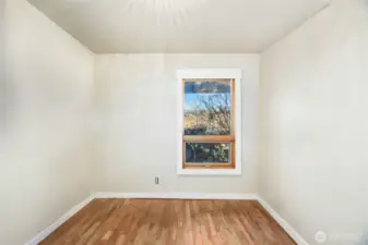 Bedroom #2  Barn door entry / Closet  Views of side garden patio  Beautiful hardwood floors