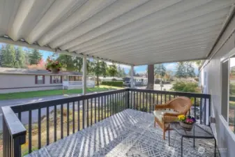 This large covered porch is such a cheerful place to enjoy the out-of-doors.